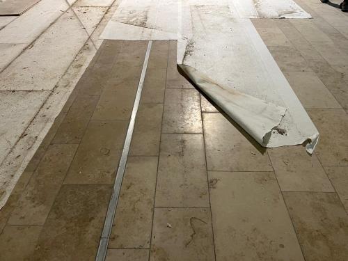 Efflorescence on natural stone flooring caused by premature covering
